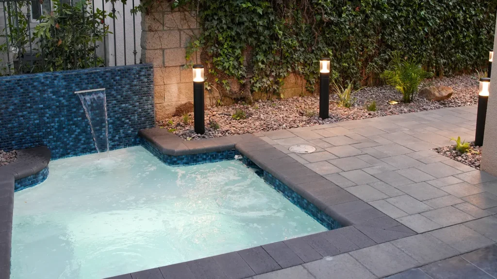 La Jolla tropical spa escape with water feature and paver walkway
