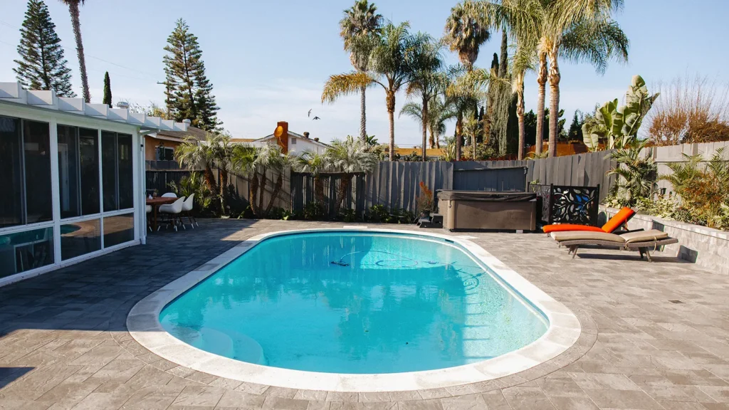 Clairemont backyard with putting green, pool decking and planters